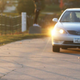 A car waits for a chicken to cross the road